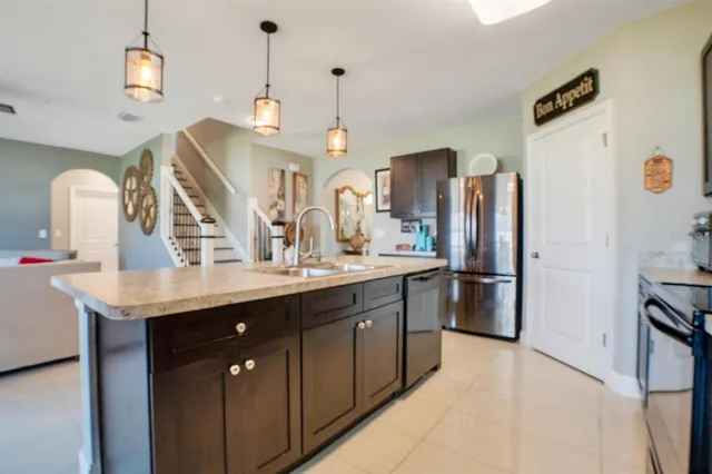 a kitchen with refrigerator a sink and cabinets