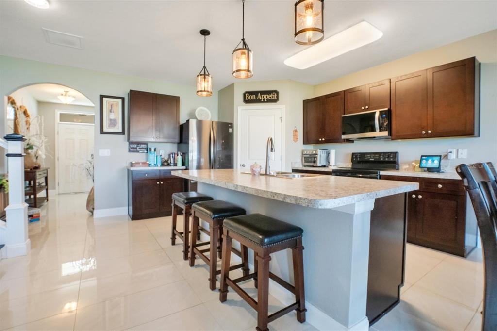 4583 Northeast 27th Street Ocala, FL 34470 - Photo 14 of 43 a kitchen with stainless steel appliances microwave stove refrigerator and microwave
