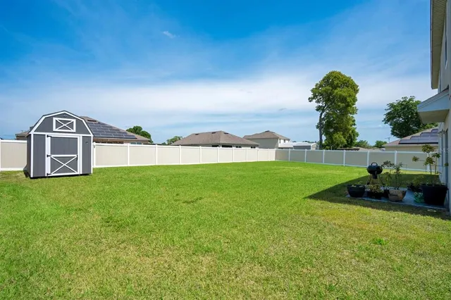 a view of a backyard with a garden and deck