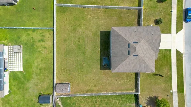 an aerial view of residential houses with outdoor space