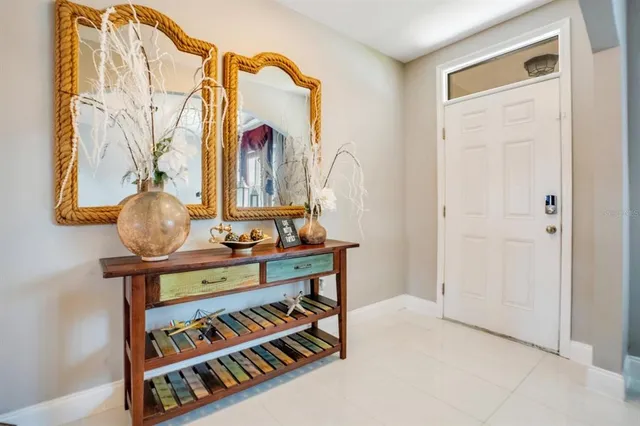 a view of hallway with a table and a potted plant