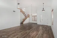 a view of a hallway with wooden floor and staircase