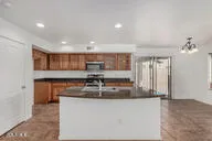 a kitchen with stainless steel appliances granite countertop a sink and a refrigerator