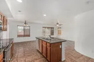 a kitchen with stainless steel appliances granite countertop a sink and a refrigerator