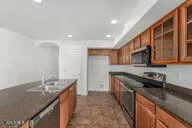 a kitchen with stainless steel appliances granite countertop a sink stove and cabinets