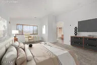 a bedroom with bed and large window