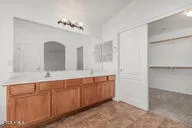 a spacious bathroom with a double vanity sink and a mirror