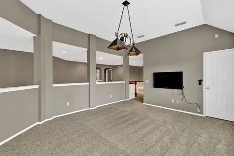 a view of a kitchen with a sink and a chandelier