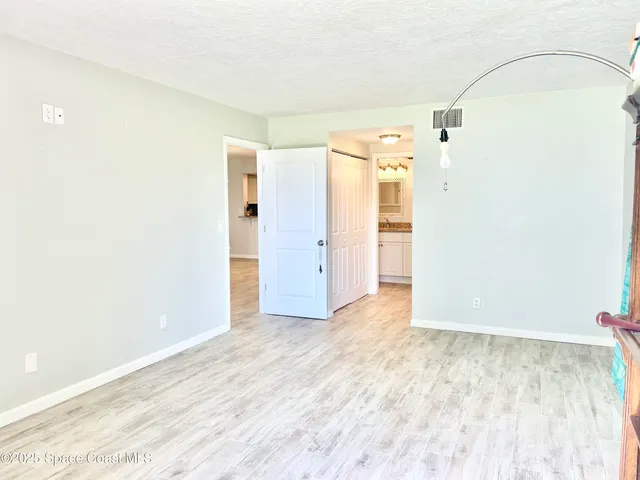 a bathroom with a granite countertop sink mirror vanity and toilet