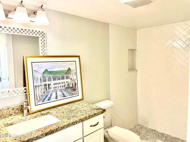 a view of a room with wooden floor and white walls