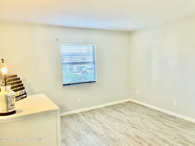a bathroom with a granite countertop sink toilet a mirror and shower