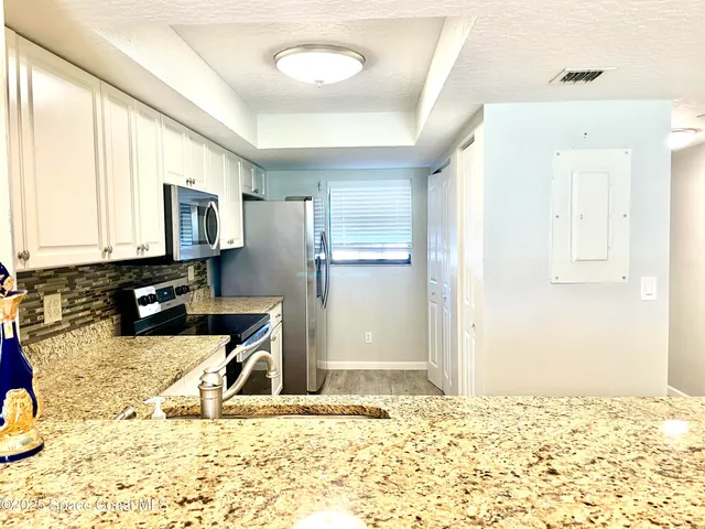 a kitchen with a refrigerator stove and sink