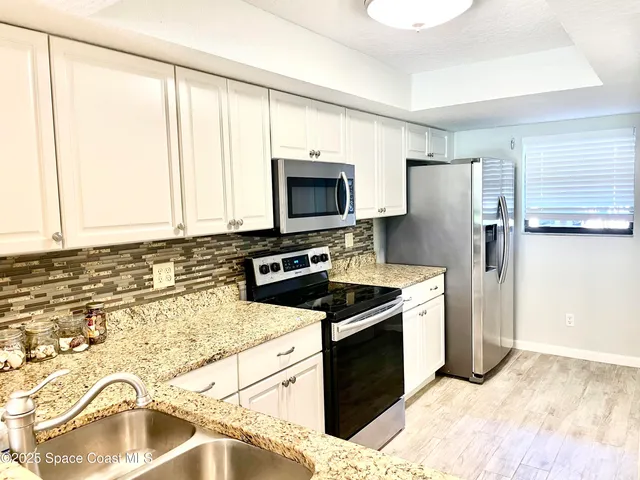 a kitchen with a stove microwave and sink