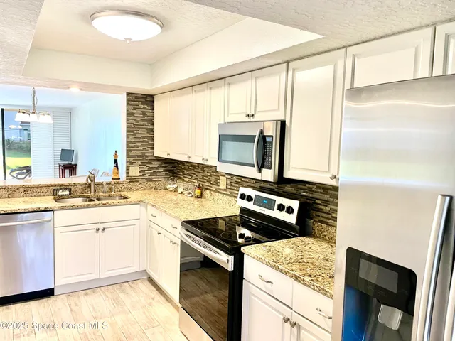 a view of a livingroom with furniture and a chandelier