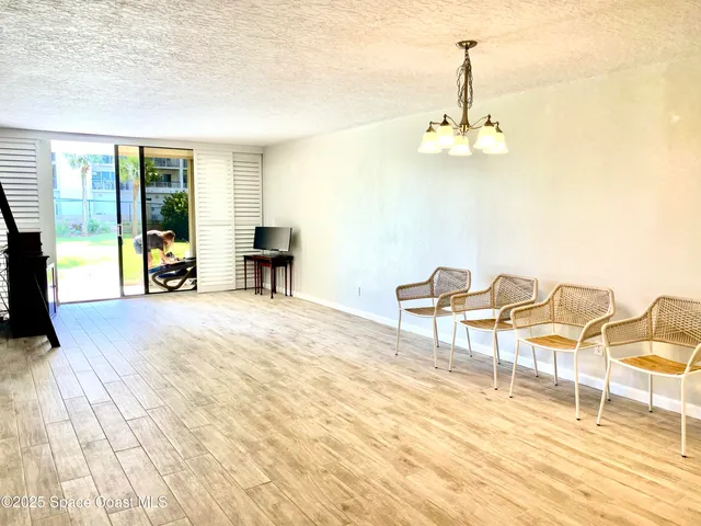 a view of a kitchen with furniture and wooden floor