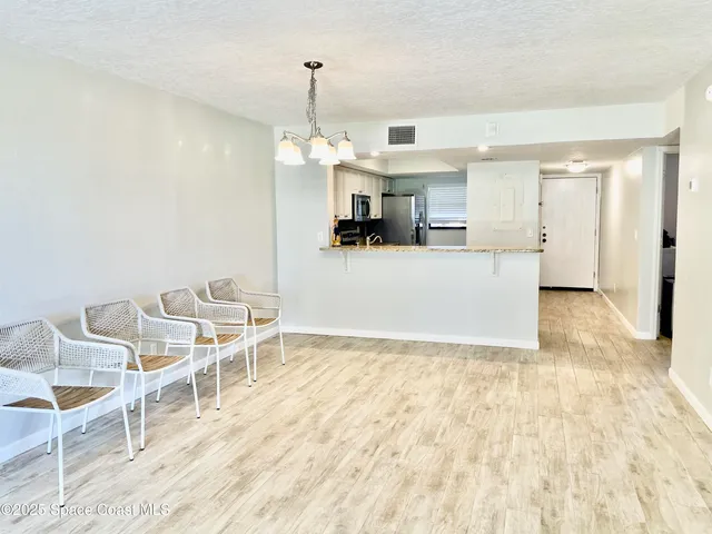 a view of a kitchen with kitchen island and wooden floor