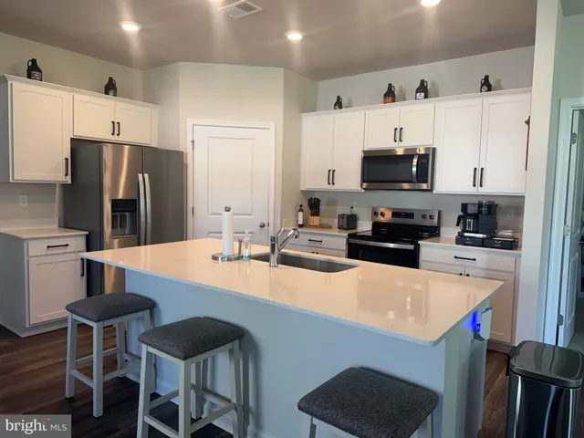 a kitchen with stainless steel appliances a refrigerator a stove a microwave and cabinets