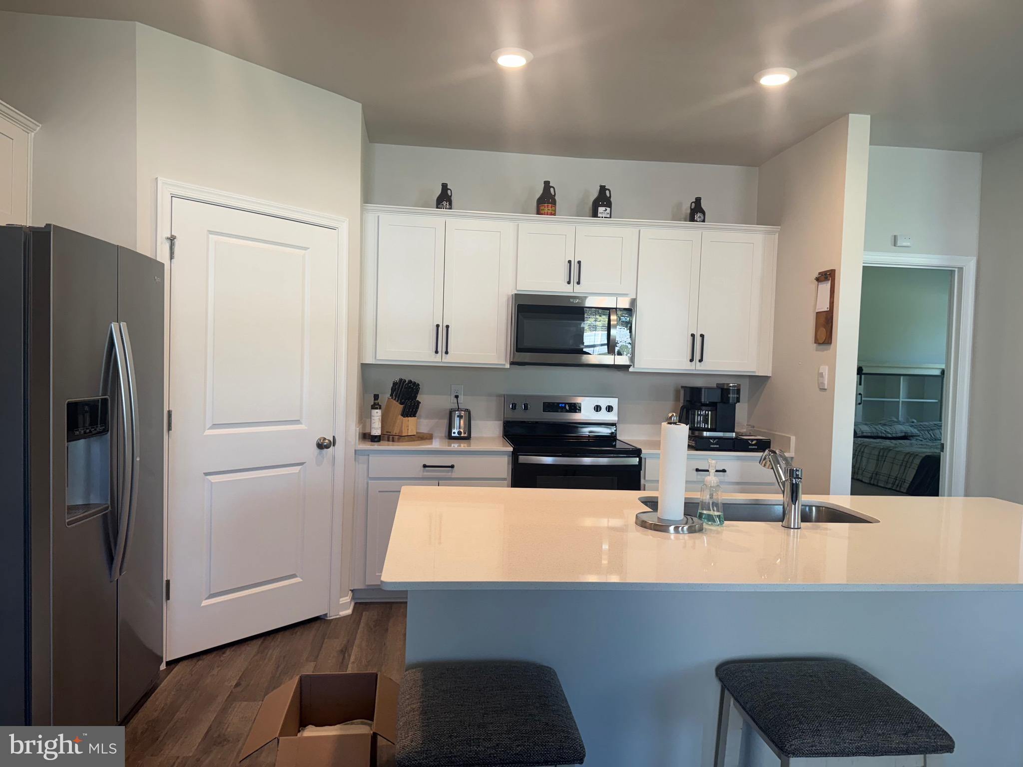 241 Atkinson Street Charles Town, WV 25414 - Photo 12 of 37 a kitchen with stainless steel appliances a refrigerator a stove a microwave and cabinets