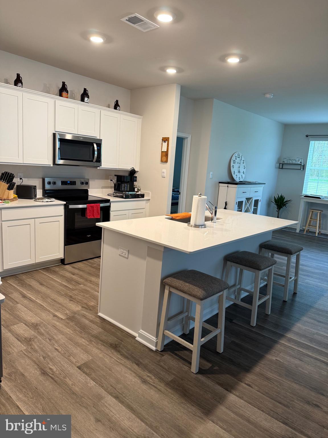 241 Atkinson Street Charles Town, WV 25414 - Photo 13 of 37 a kitchen with a dining table chairs and white cabinets