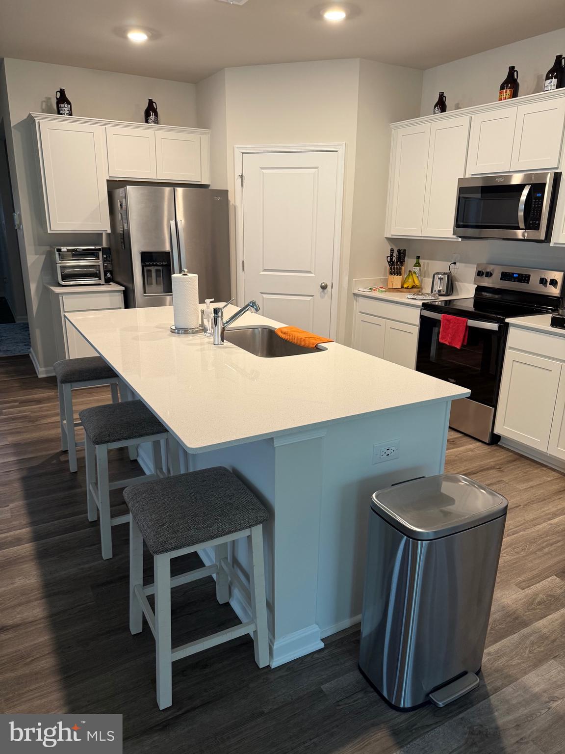 241 Atkinson Street Charles Town, WV 25414 - Photo 14 of 37 a kitchen with kitchen island a stove a microwave a sink and cabinets