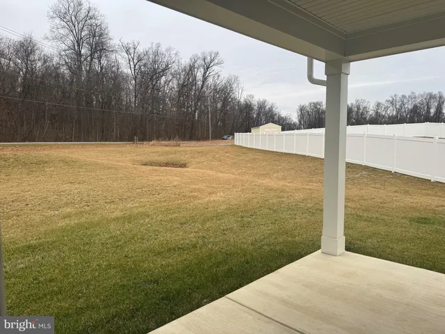 a view of a hallway with wooden floor and closet