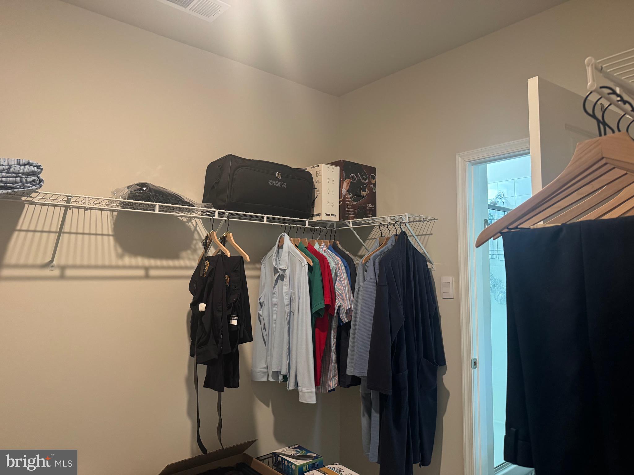 241 Atkinson Street Charles Town, WV 25414 - Photo 23 of 37 a view of walk in closet with clothes and shoes