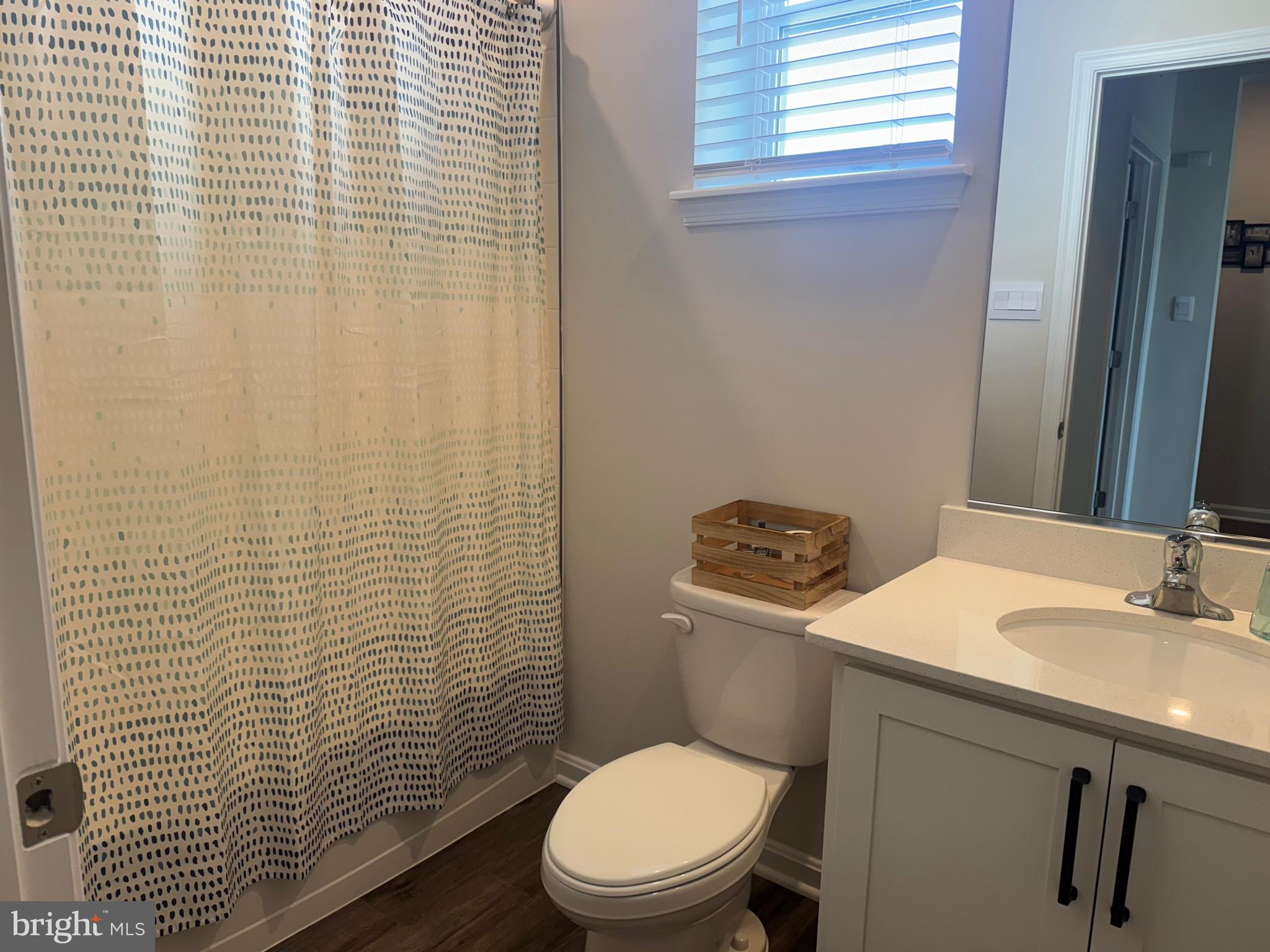 241 Atkinson Street Charles Town, WV 25414 - Photo 25 of 37 a bathroom with a toilet a sink and shower curtain