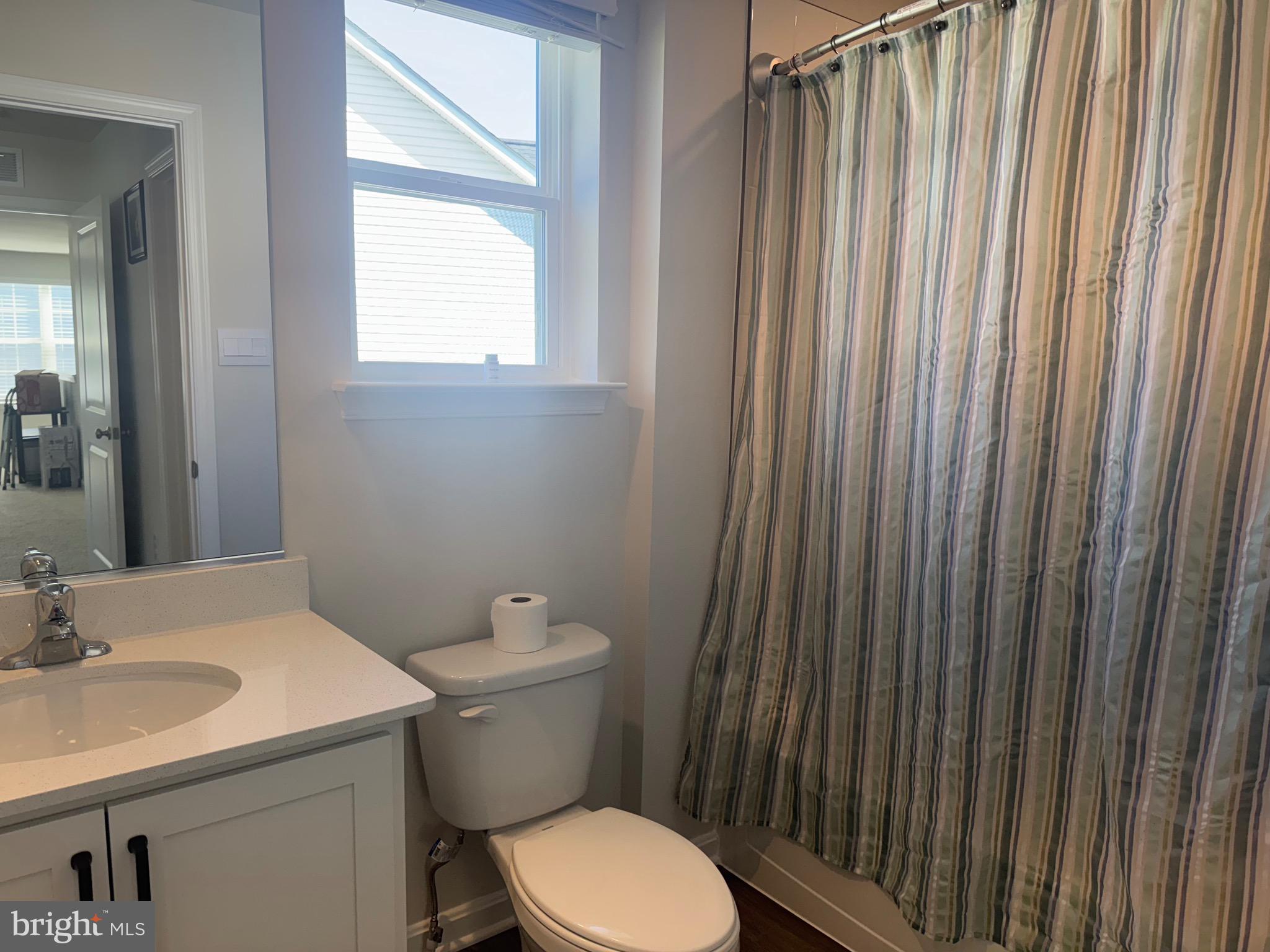 241 Atkinson Street Charles Town, WV 25414 - Photo 30 of 37 a bathroom with a sink a toilet and shower curtain