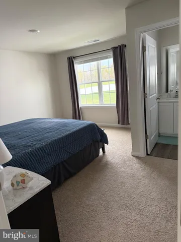 a bedroom with a bed and a night stand