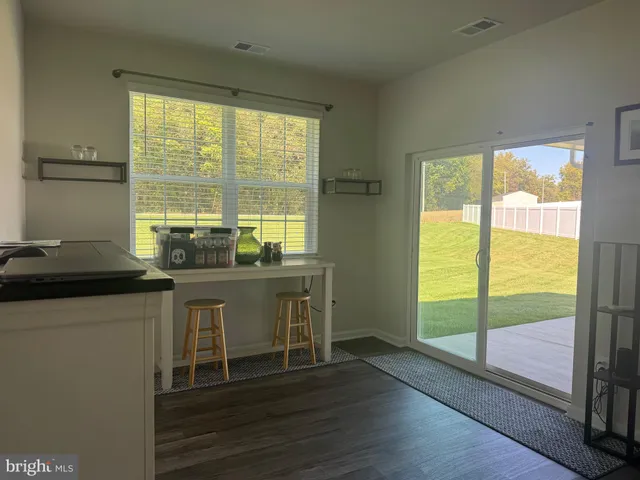 a room with wooden floor and a window