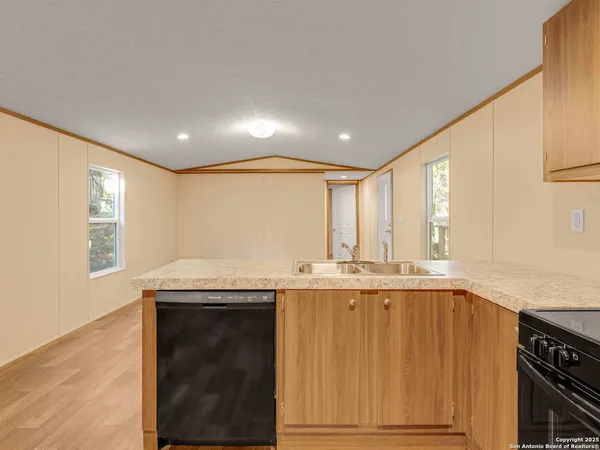 a view of a kitchen with a sink and cabinets