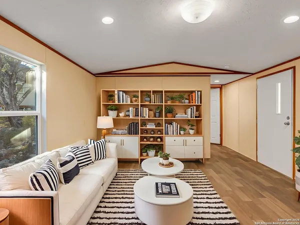 a living room with furniture and wooden floor