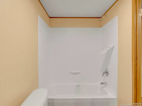 a bathroom with a shower curtain and a toilet