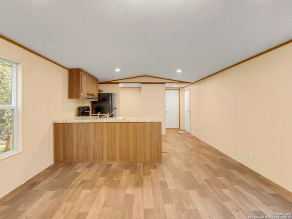 a view of kitchen with wooden floor and electronic appliances
