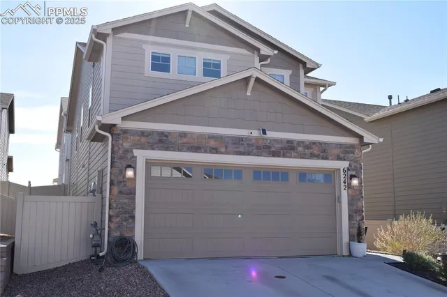 a front view of a house with a garage
