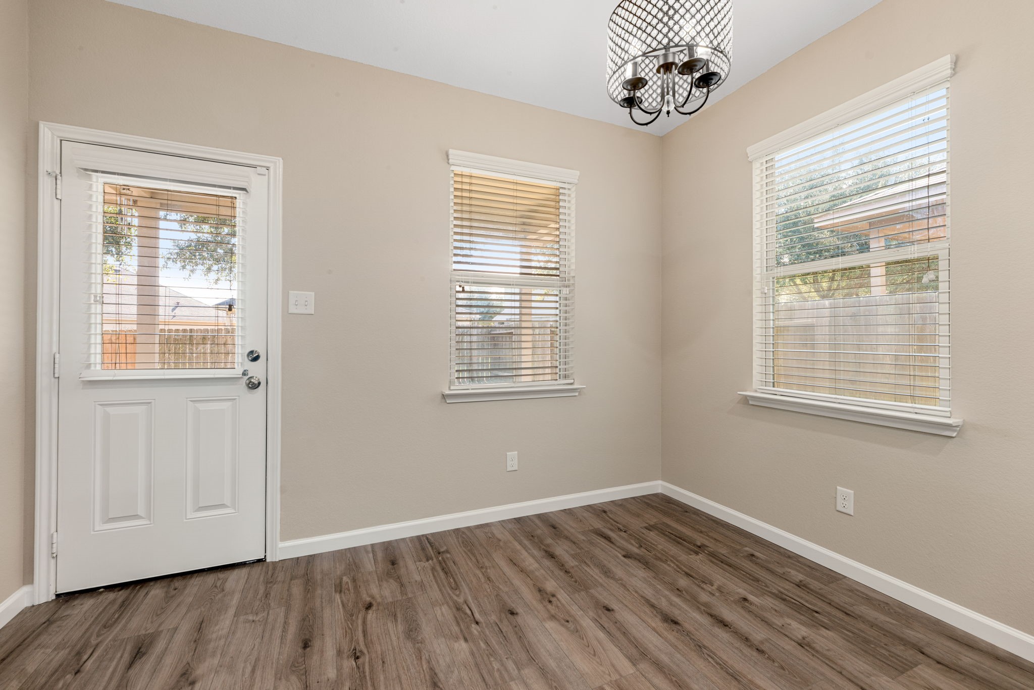 11429 West Woodmark Conroe, TX 77304 - Photo 13 of 29 a view of an empty room with wooden floor and a window