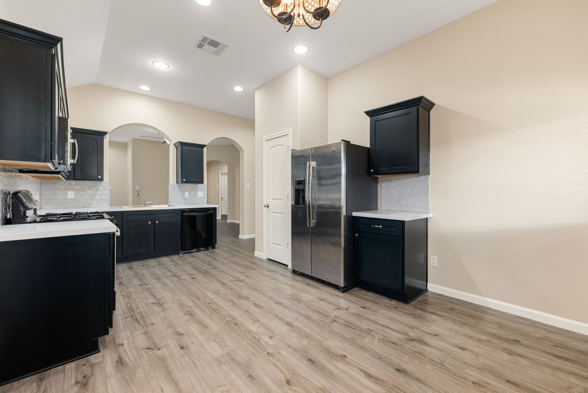 11429 West Woodmark Conroe, TX 77304 - Photo 14 of 29 a kitchen with stainless steel appliances a refrigerator and a sink