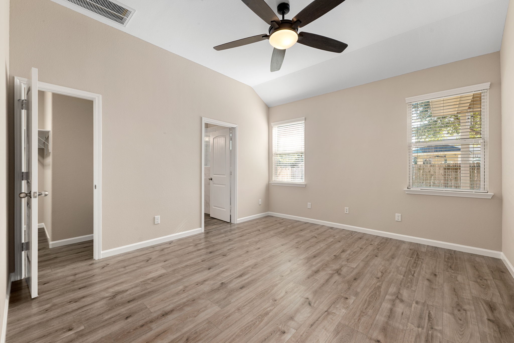 11429 West Woodmark Conroe, TX 77304 - Photo 16 of 29 a view of an empty room with wooden floor and a window