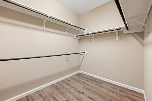 a view of small space with racks on the wall and a window