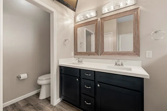 a bathroom with a double vanity sink and a mirror