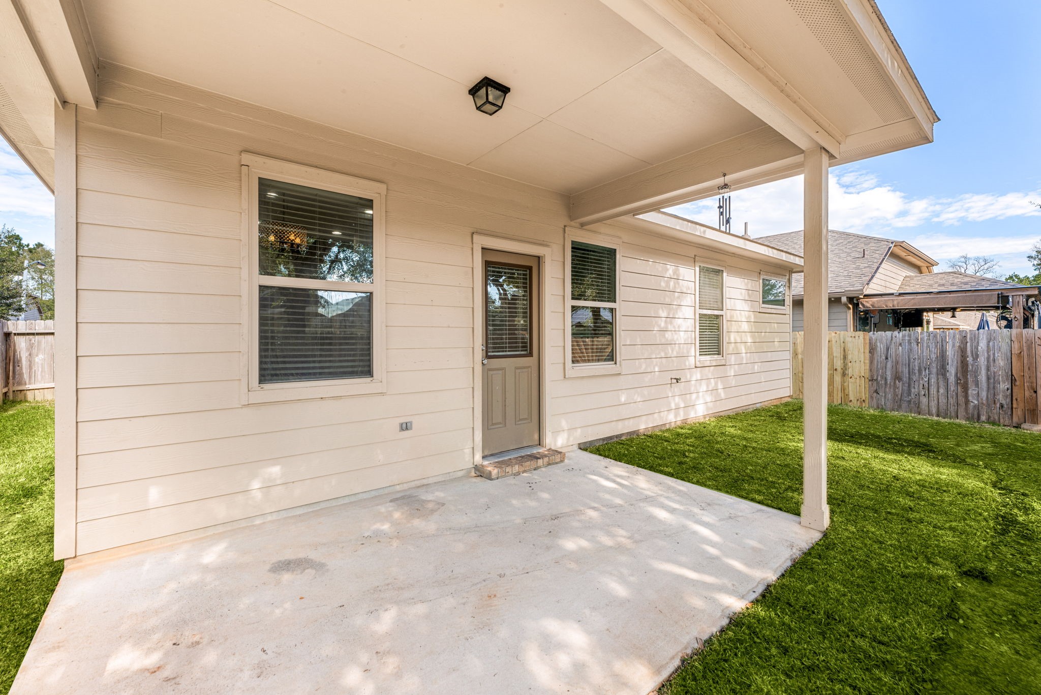 11429 West Woodmark Conroe, TX 77304 - Photo 26 of 29 a view of a house with backyard and porch