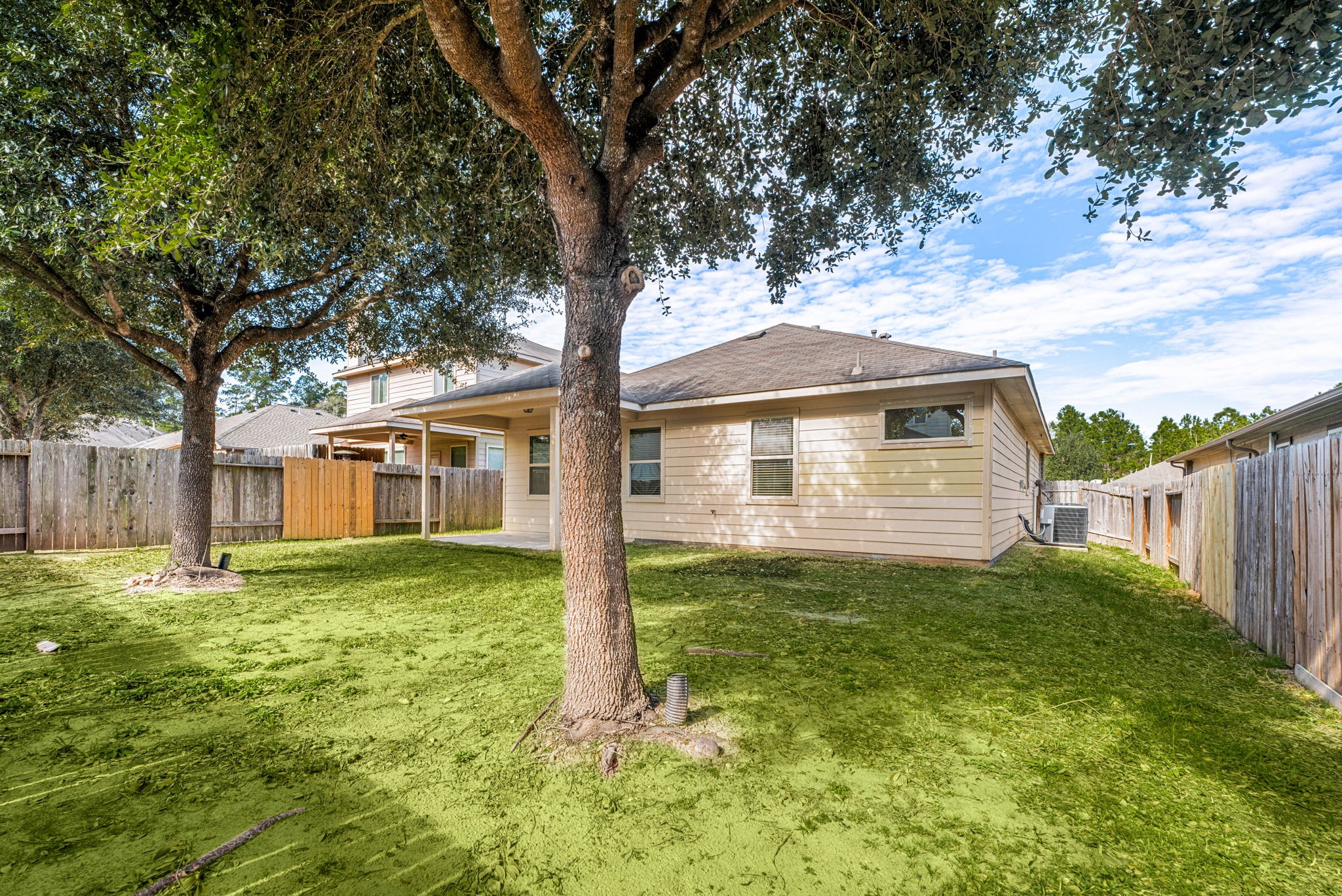 11429 West Woodmark Conroe, TX 77304 - Photo 29 of 29 a view of a house with a yard