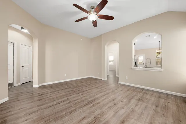 wooden floor in an empty room with a window