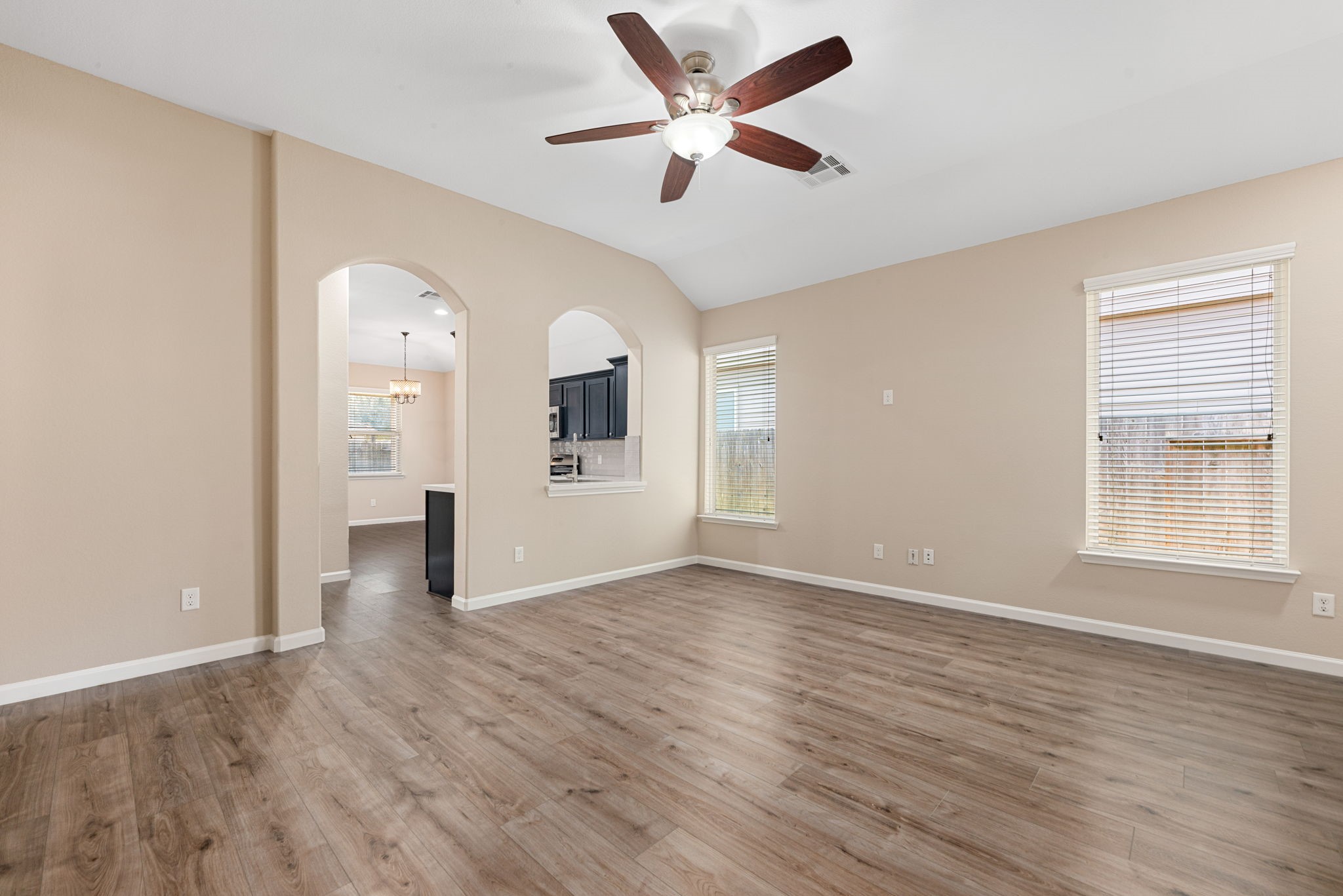 11429 West Woodmark Conroe, TX 77304 - Photo 7 of 29 an empty room with wooden floor and windows