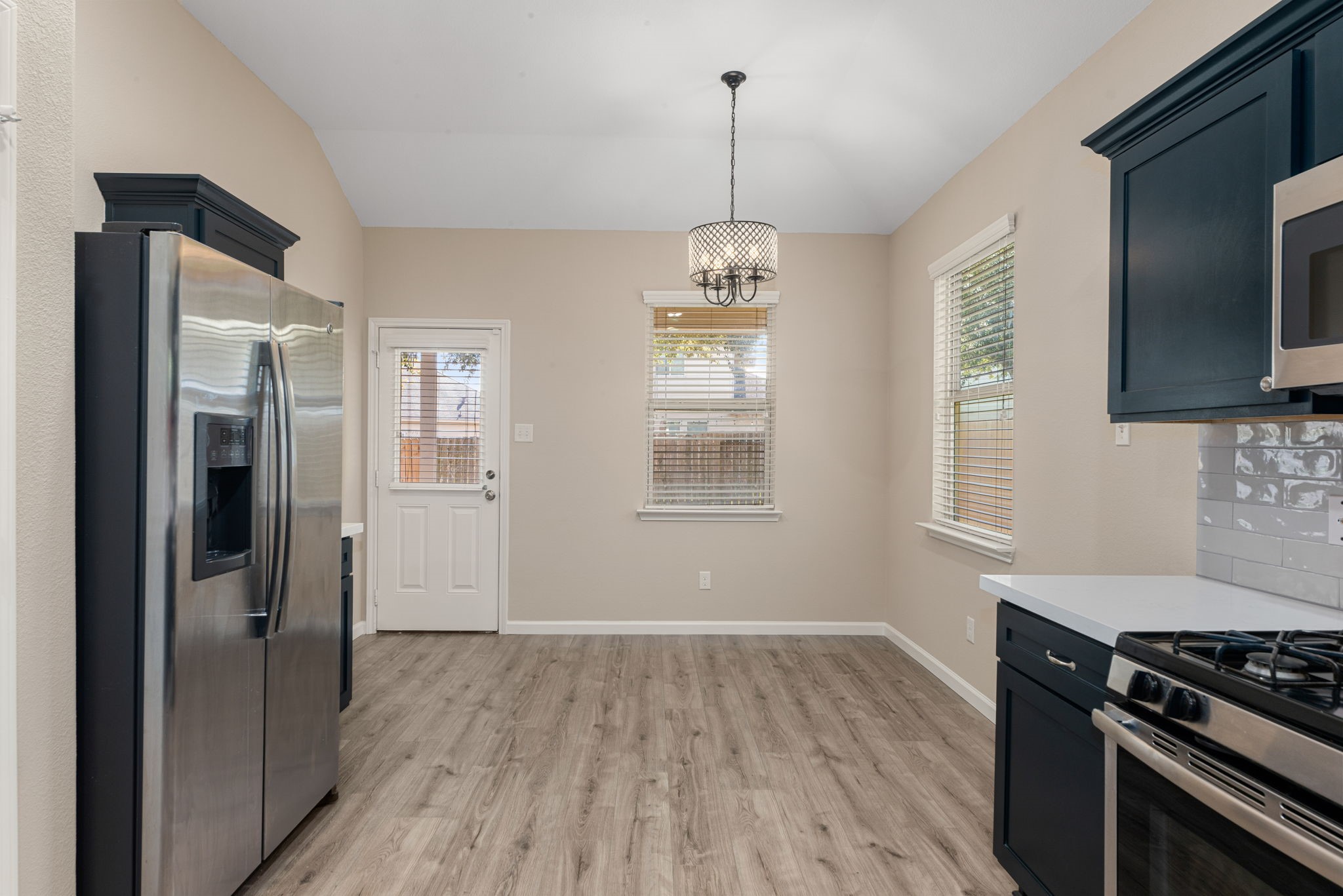 11429 West Woodmark Conroe, TX 77304 - Photo 10 of 29 a kitchen with stainless steel appliances granite countertop a stove and a wooden floors