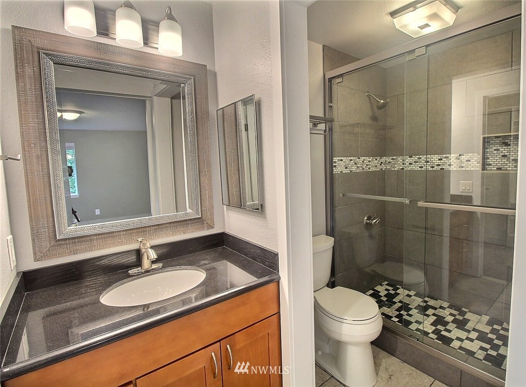 19404 Bothell Way Northeast, Unit B304 Bothell, WA 98011 - Photo 17 of 38 a bathroom with a sink a toilet and shower