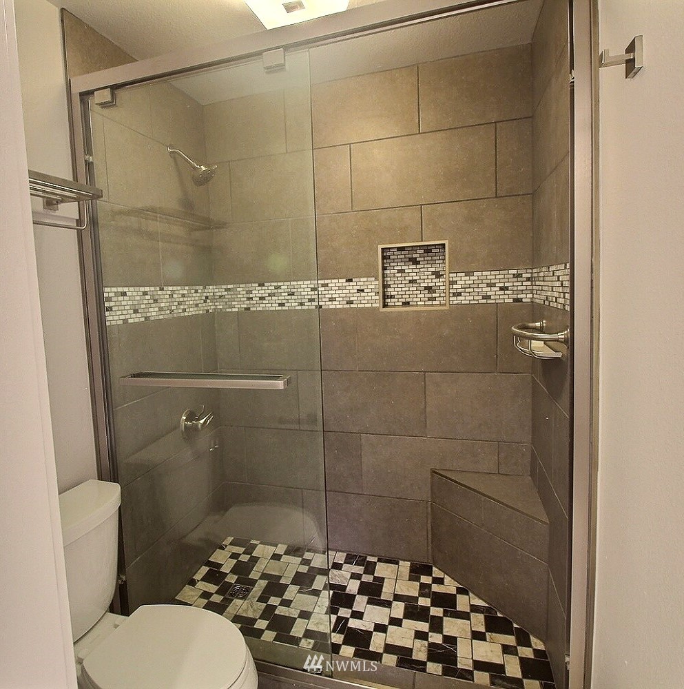 19404 Bothell Way Northeast, Unit B304 Bothell, WA 98011 - Photo 18 of 38 a bathroom with a toilet and a shower