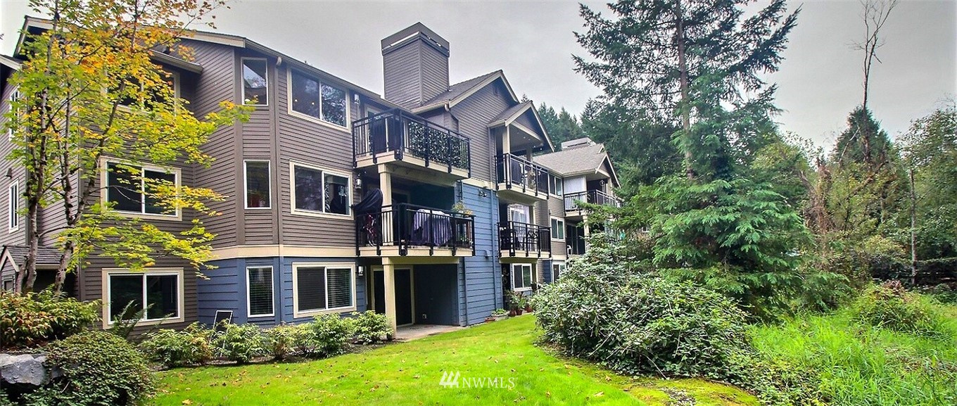 19404 Bothell Way Northeast, Unit B304 Bothell, WA 98011 - Photo 31 of 38 a view of a big house with plants and large trees and plants in front of main door