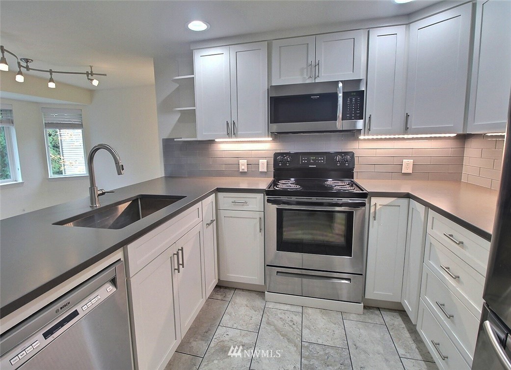 19404 Bothell Way Northeast, Unit B304 Bothell, WA 98011 - Photo 6 of 38 a kitchen with cabinets stainless steel appliances and a counter space