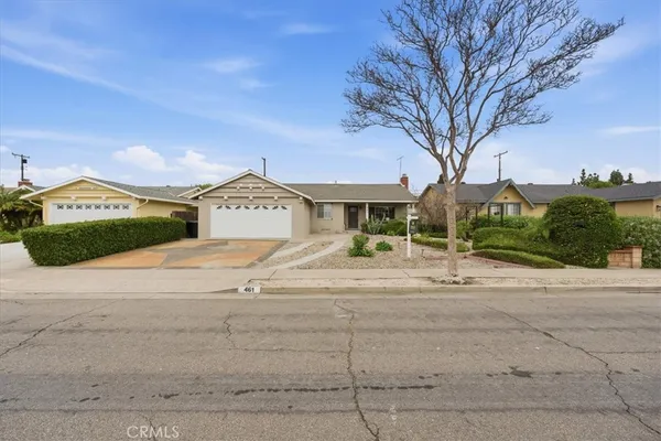 a view of a house with a yard and garage